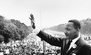 Dr. Martin Luther King, Jr. waving to a crowd at the Capitol Building.